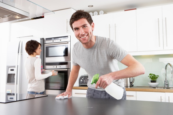 Young Couple Cleaning Cleaning Modern Kitchen
